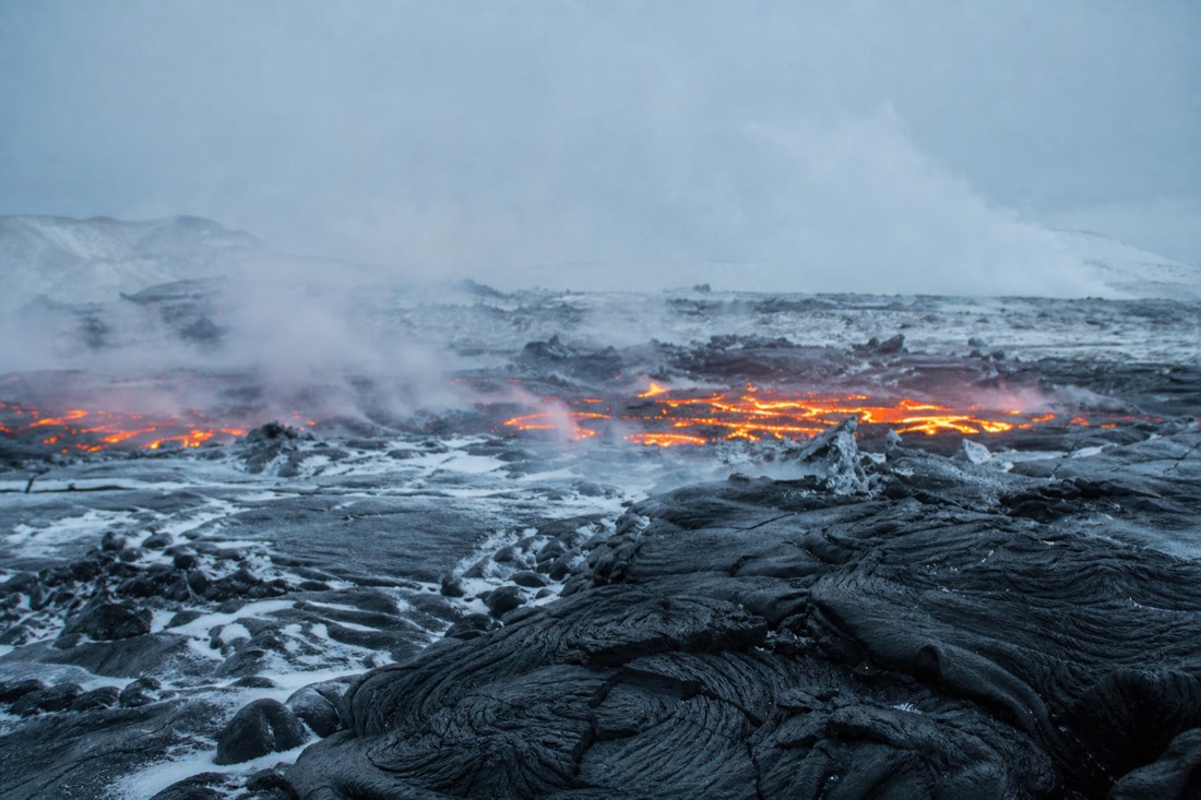 Steaming lava field on the Reykjanes peninsula under overcast winter light, no people in sight