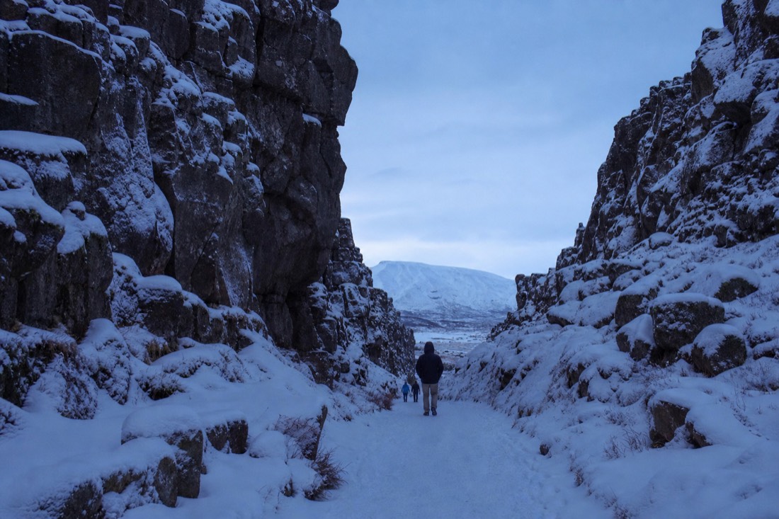 The snowy rift valley path at Þingvellir National Park on a Golden Circle winter tour
