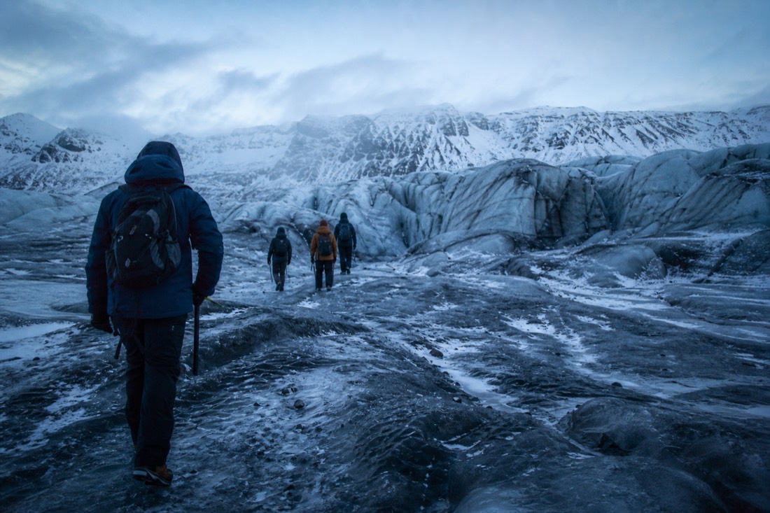 A small group walking a glacier tongue in Skaftafell on a Vatnajökull glacier hike