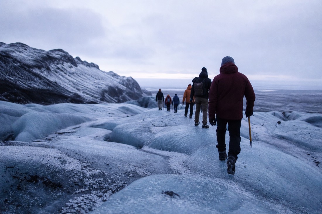 A small-group glacier hike on the blue ice of Sólheimajökull in winter