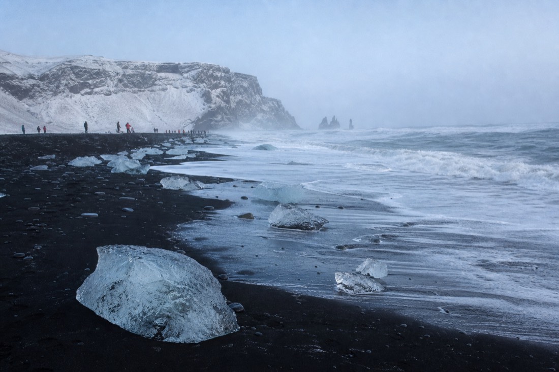 Waves breaking on the black sand of Reynisfjara on a full-day South Coast winter tour