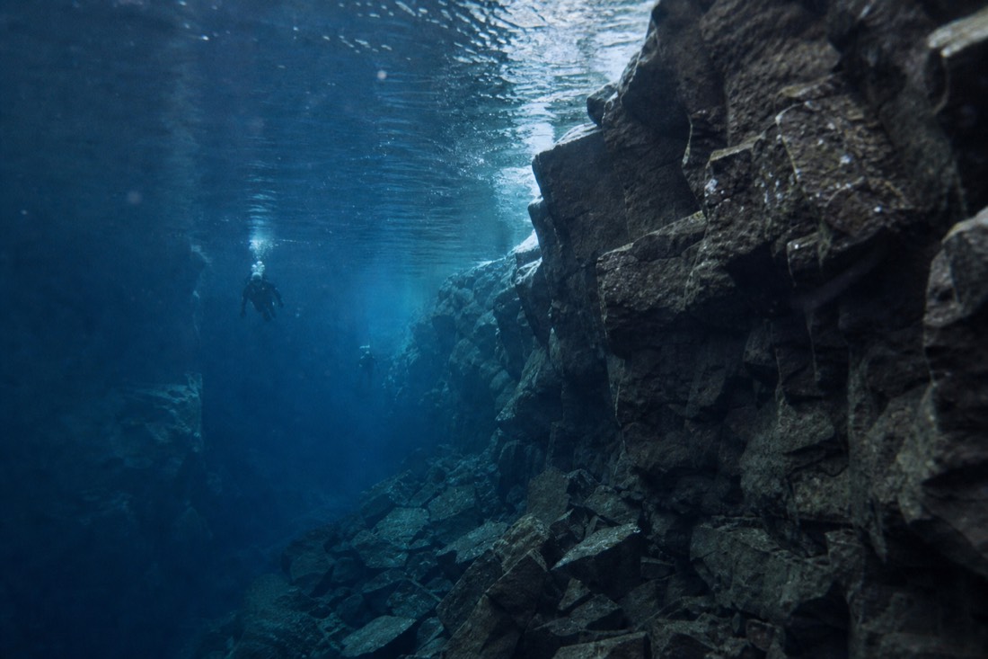 An underwater view along the rock walls of the Silfra fissure in Þingvellir National Park