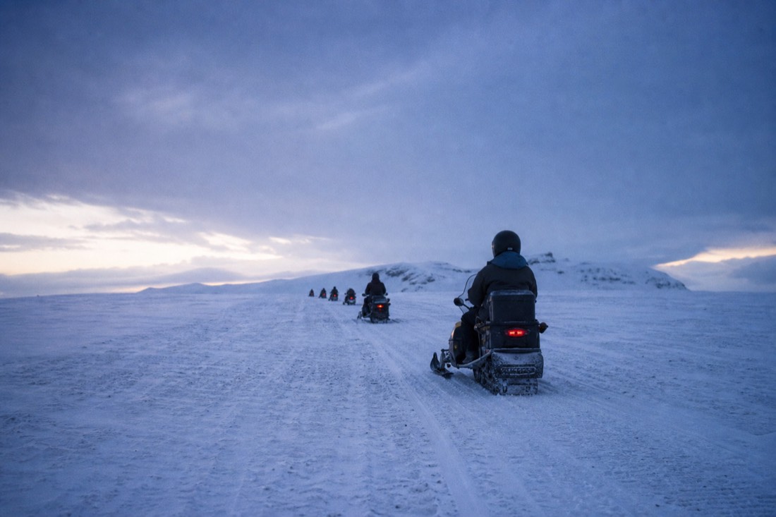 A snowmobile crossing Langjökull glacier on a tour meeting at Gullfoss