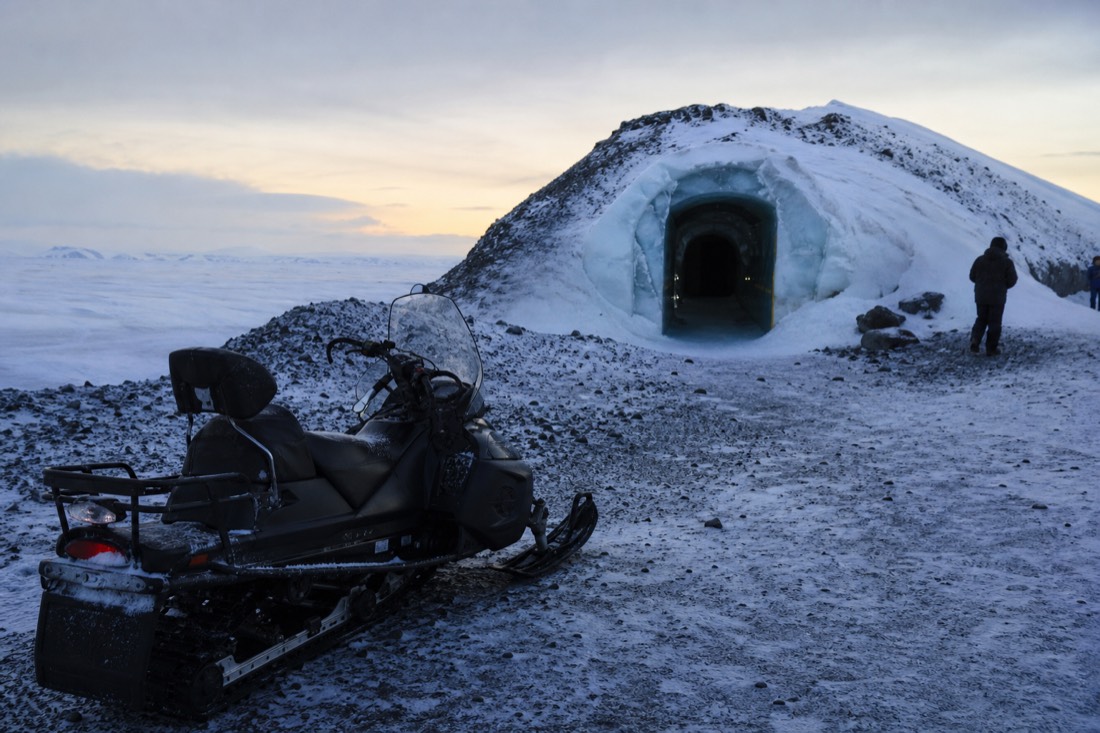 A snowmobile parked outside an ice tunnel entrance on Langjökull glacier