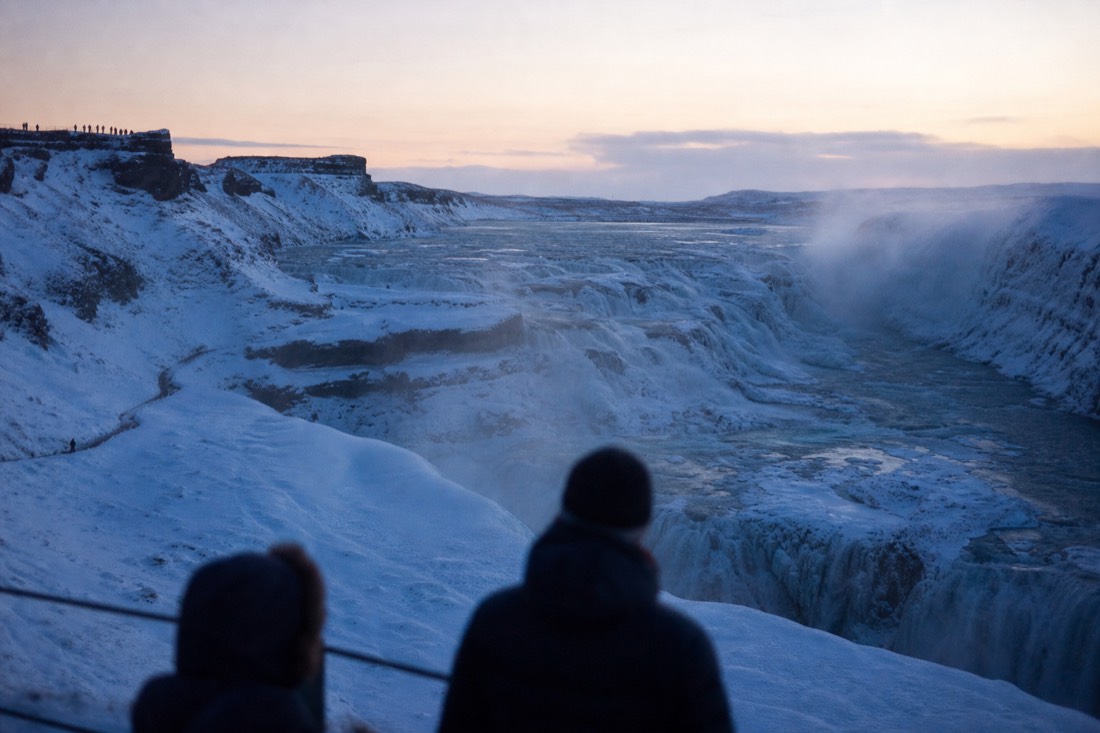 Gullfoss waterfall half frozen in spray on a Golden Circle winter tour