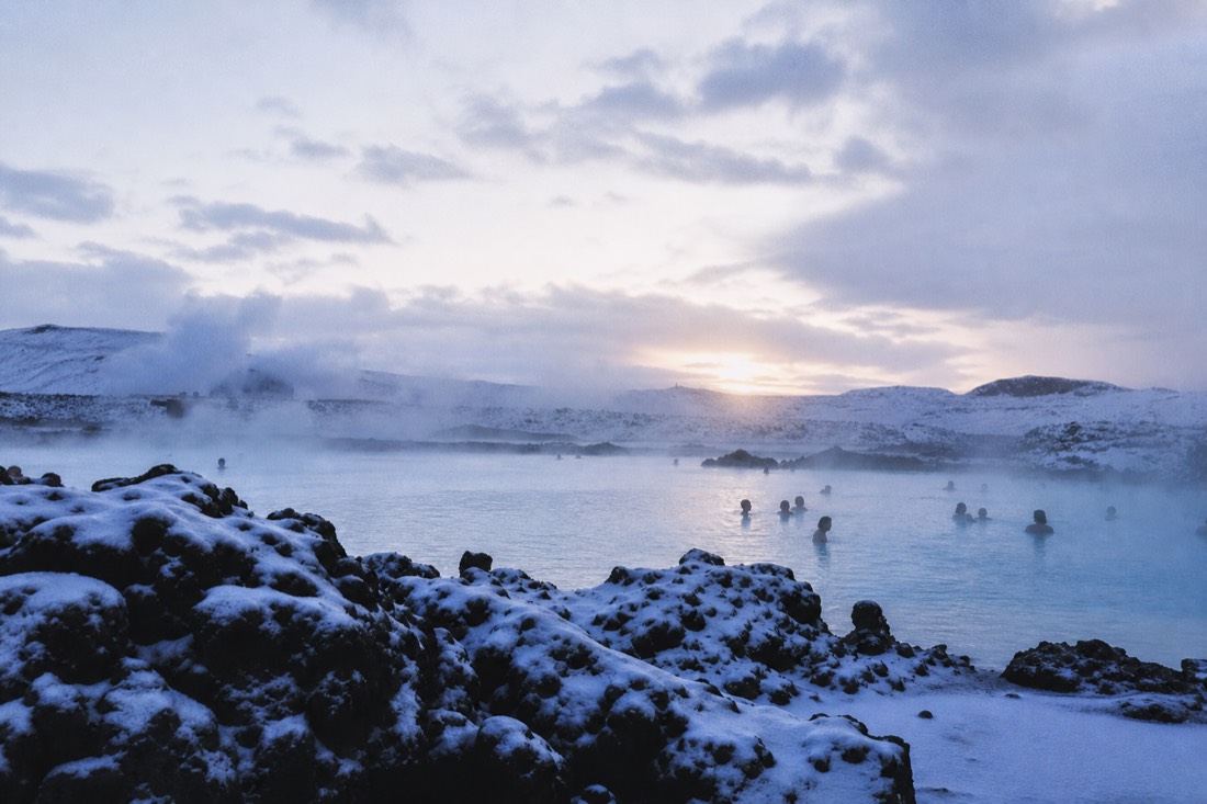 Steam rising off a geothermal lagoon in the snow near Reykjavík in winter