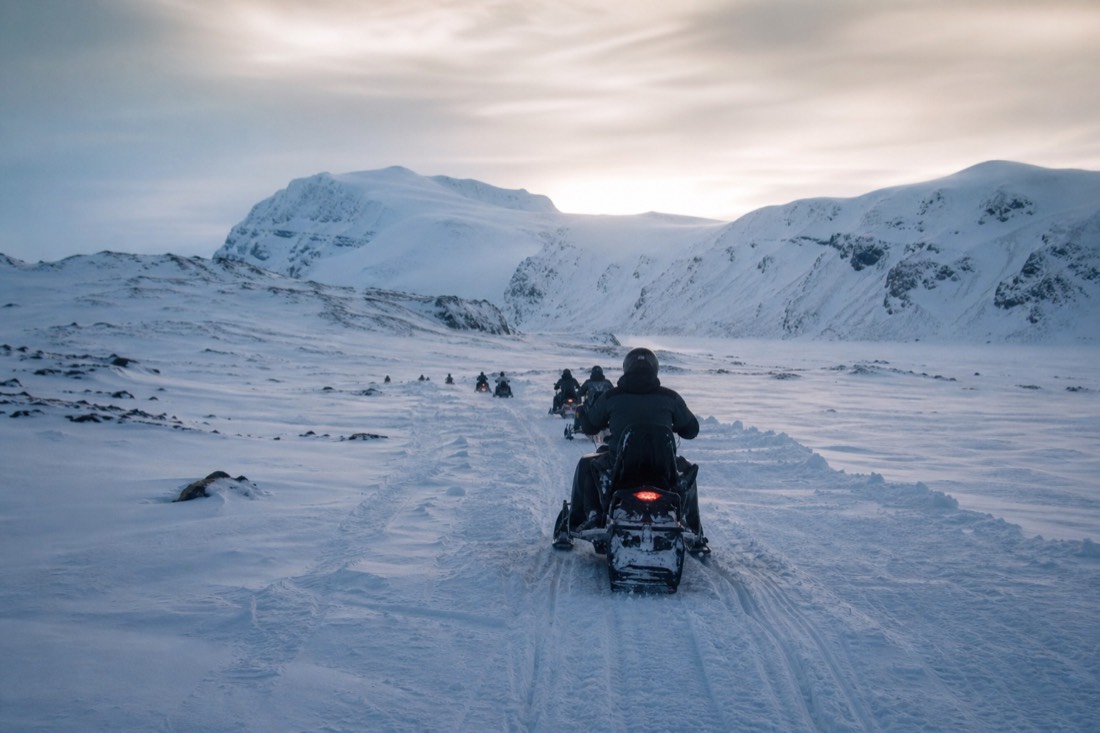 Snowmobiles crossing the white expanse of Langjökull glacier on a winter tour