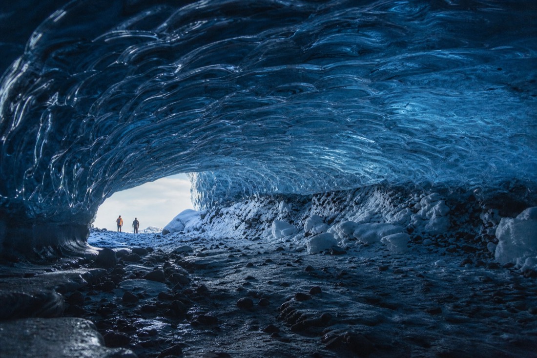 Blue ribbed ceiling of a natural Vatnajokull ice cave lit by daylight through the entrance