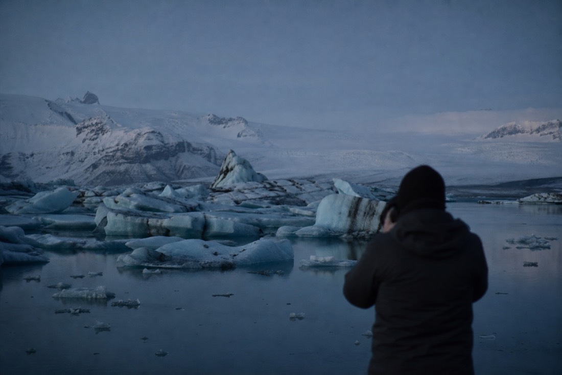 Blue hour over Jokulsarlon glacier lagoon, ice blocks stranded on dark still water