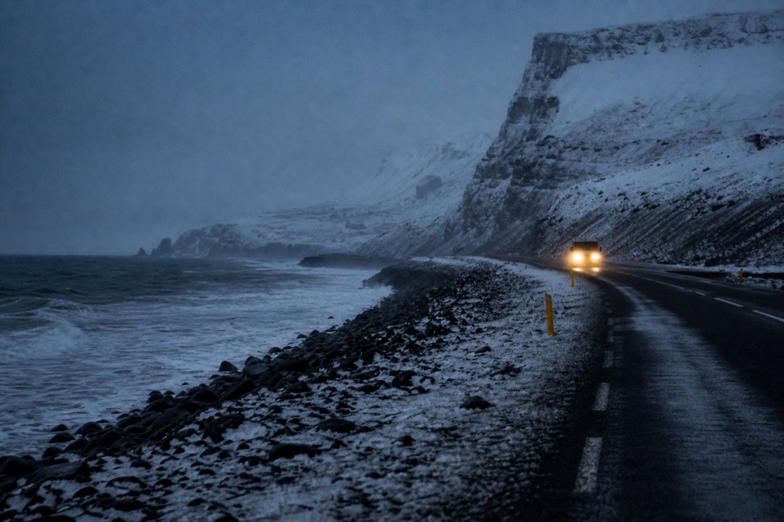 Coach headlights on a dark snowy South Coast road at four in the afternoon in December