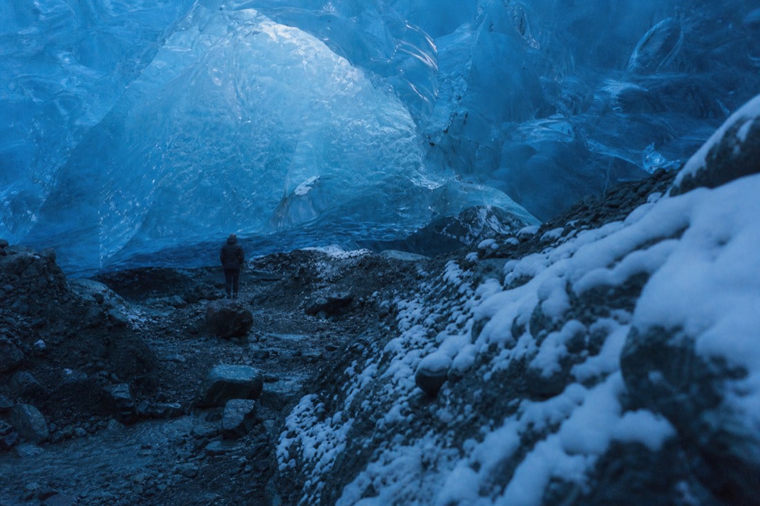 Deep blue chamber inside a Vatnajokull ice cave with daylight coming through the thin roof
