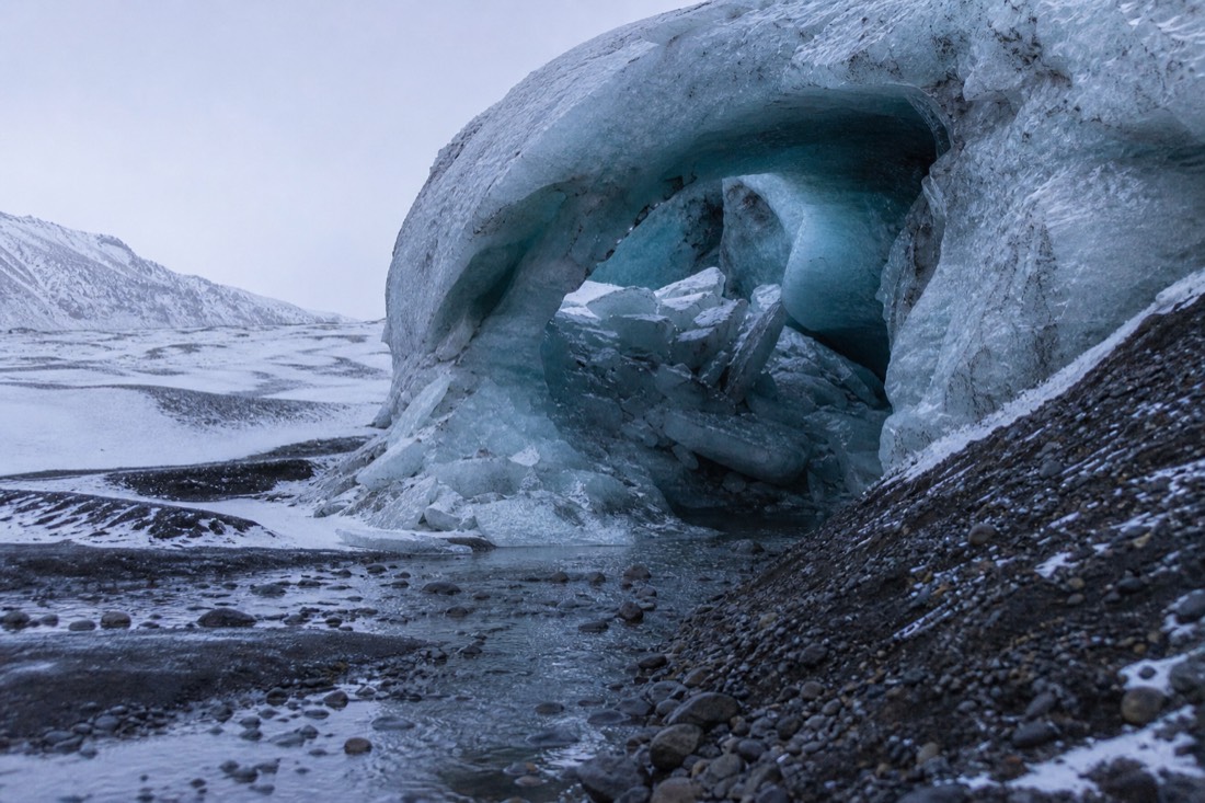 Meltwater channel cut through glacier ice, entrance half collapsed, flat overcast light