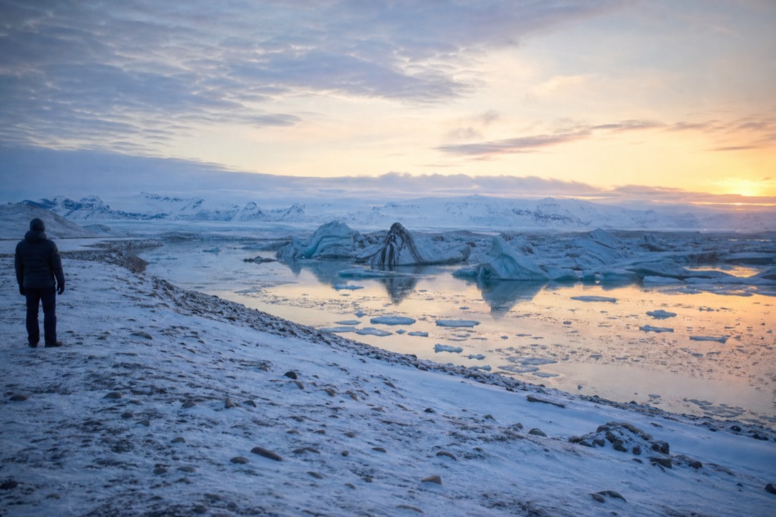 February morning light on Jokulsarlon lagoon with stranded icebergs and a frozen shoreline